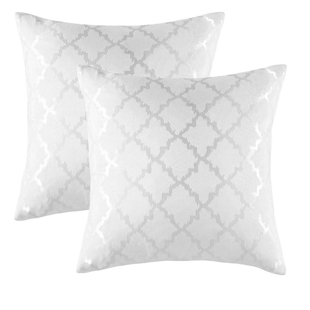 Modern geometric pillow covers arranged on sofa showcasing polyester fabric and contemporary design appeal