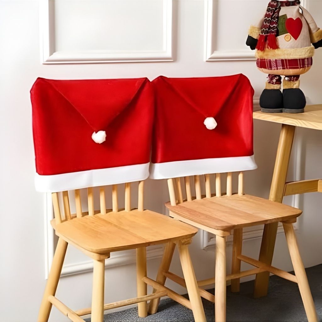 Red and white Santa hat chair cover draped over dining chair back