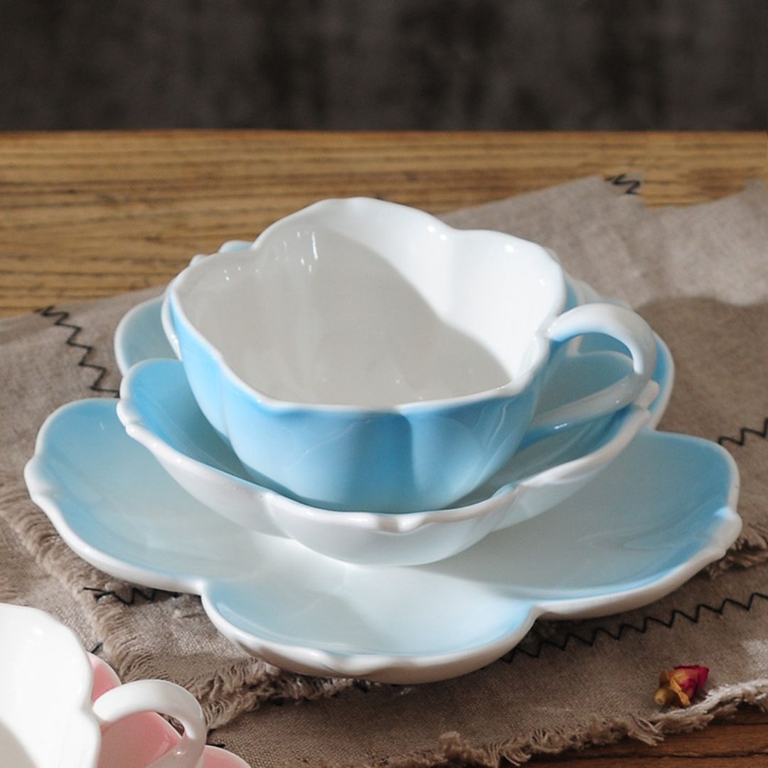 Japanese style porcelain tea cup with delicate floral silhouette and matching accessories