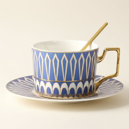 Porcelain tea cup with geometric pattern and gold handle on matching saucer