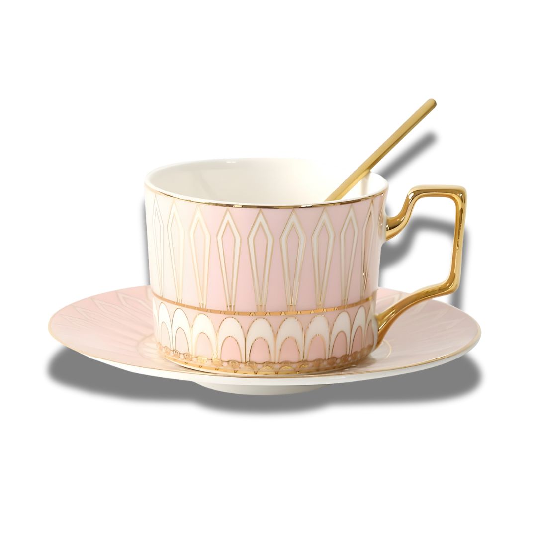 White porcelain tea cup and saucer with gold handle and geometric design