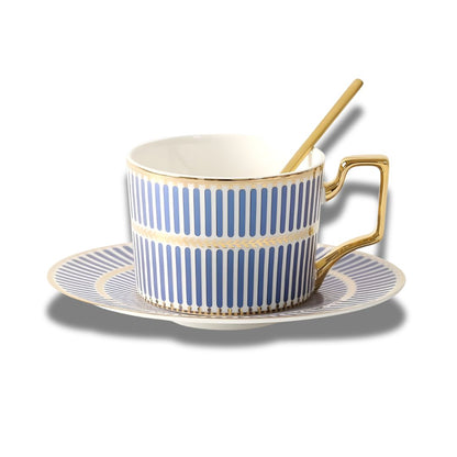 Porcelain cup with gold spoon and saucer featuring geometric border pattern