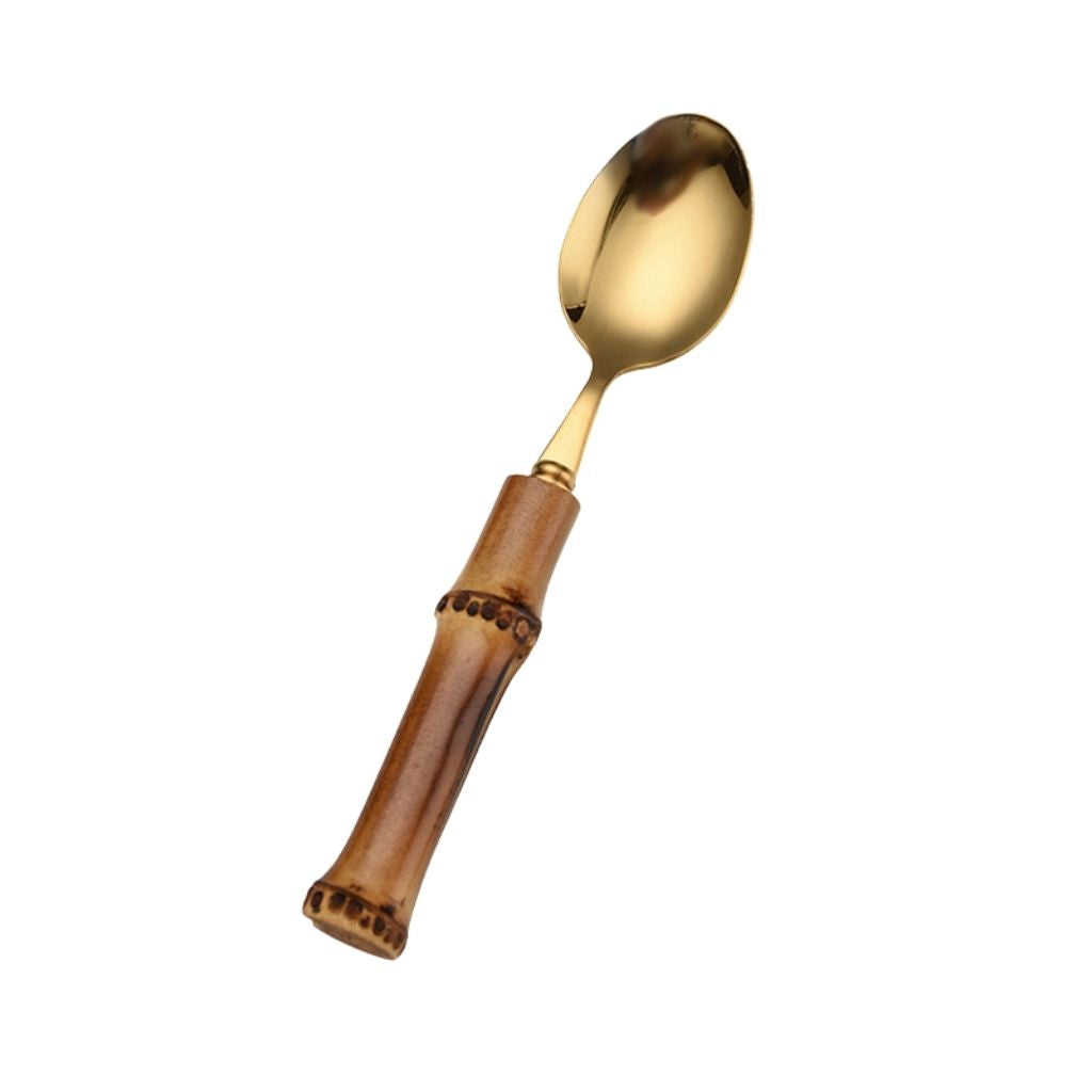 Stainless steel cutlery with natural bamboo handles showcasing golden tones and artisanal design