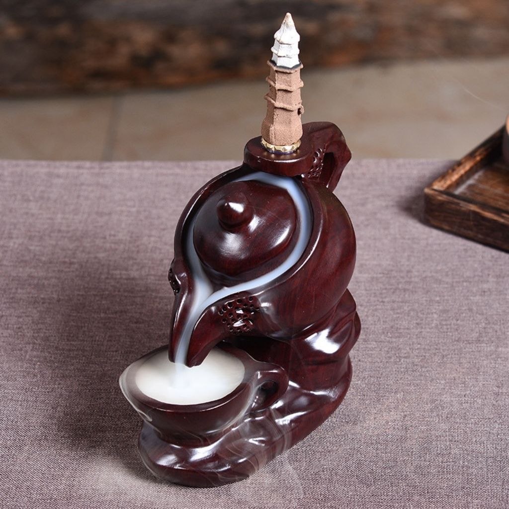 Hand carved ebony incense holder with organic teapot form and glossy black coating