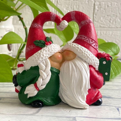 Resin Christmas ornament showing gnome pair in festive winter attire