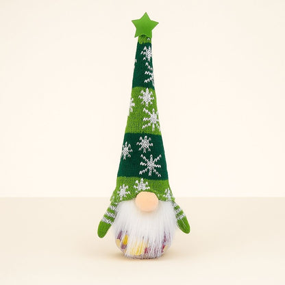 Christmas gnome decoration with white fluffy beard and red knitted hat on white background