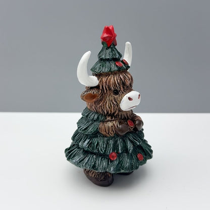 Compact resin decoration showing highland cow with seasonal tree design