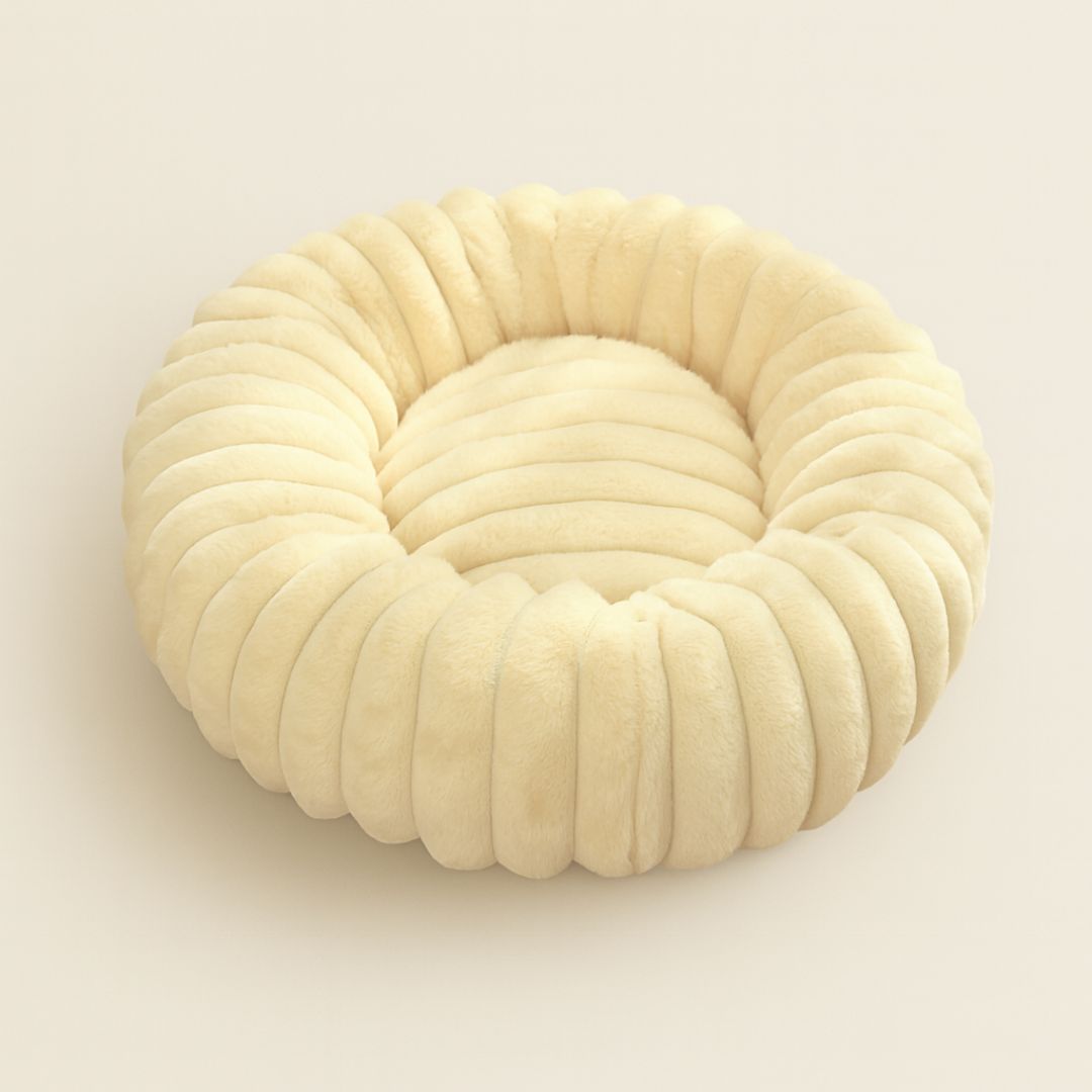 Donut shaped calming dog bed with bolster edges for anxiety relief and comfort