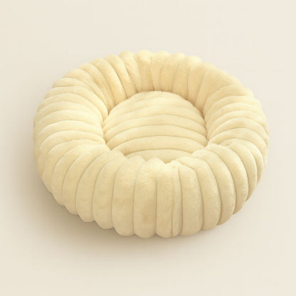 Donut shaped calming dog bed with bolster edges for anxiety relief and comfort