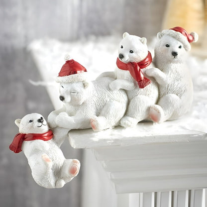 Set of white polar bear figurines with red scarves and hats on a decorative stand.