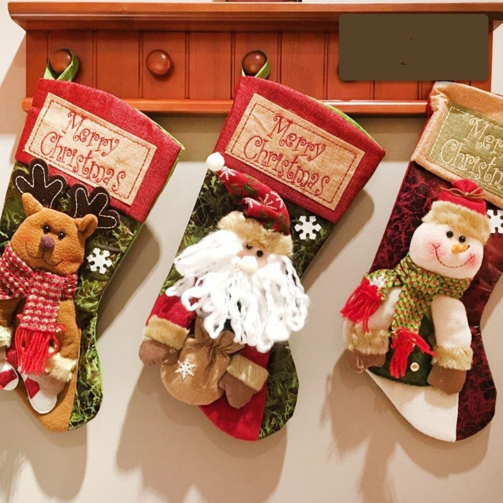 Cloth Christmas stocking with handmade reindeer character for seasonal decorating