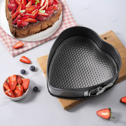 Heart-shaped cake pan on a wooden board with strawberries and blueberries around