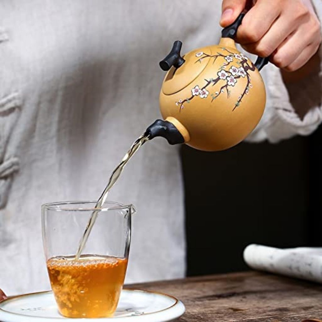 Full view of handcrafted purple sand clay teapot with decorative relief work