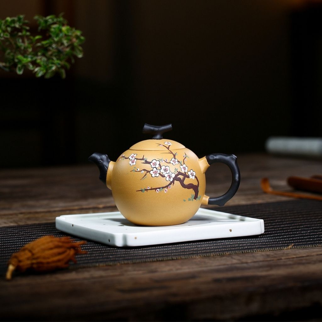 Detail of curved ergonomic handle on handmade purple sand clay teapot