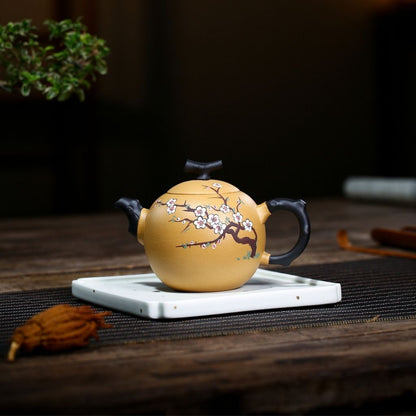 Detail of curved ergonomic handle on handmade purple sand clay teapot