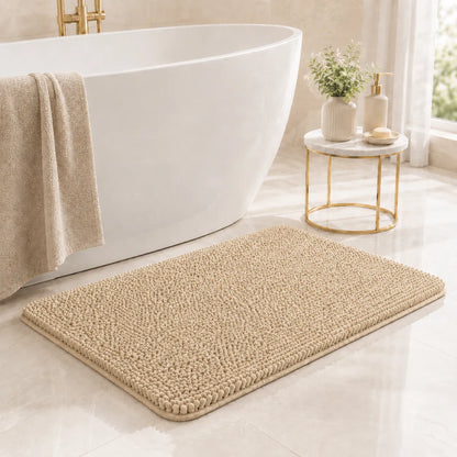 Camel bath mat in front of a white freestanding bathtub with a small table and decorative items.