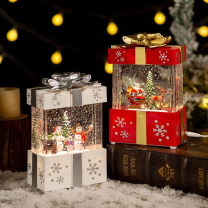 Festive table lamp displaying snow globe effect inside wrapped present design