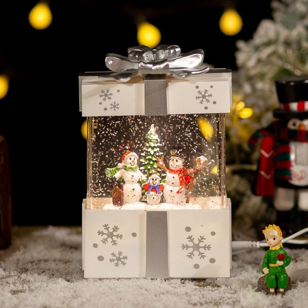 Musical snow filled lamp with gift box design and decorative bow detail
