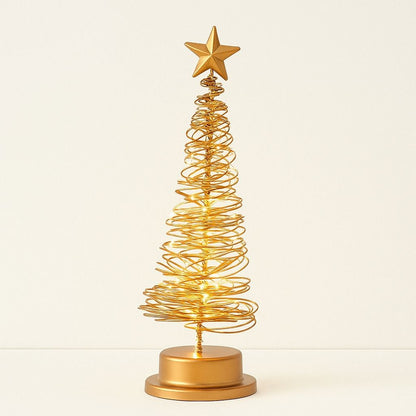 Gold wire Christmas tree with a star on top against a beige background