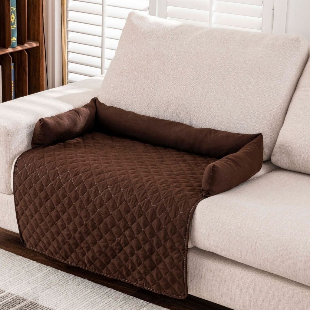 Non slip pet blanket with padded bolsters on living room furniture
