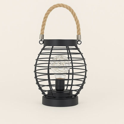 Black lamp wire cage lantern with a rope handle on a beige background