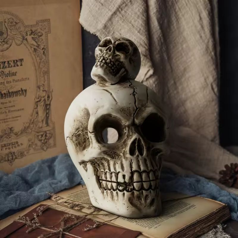 Skull-shaped decorative item on an open book with a classical music sheet in the background
