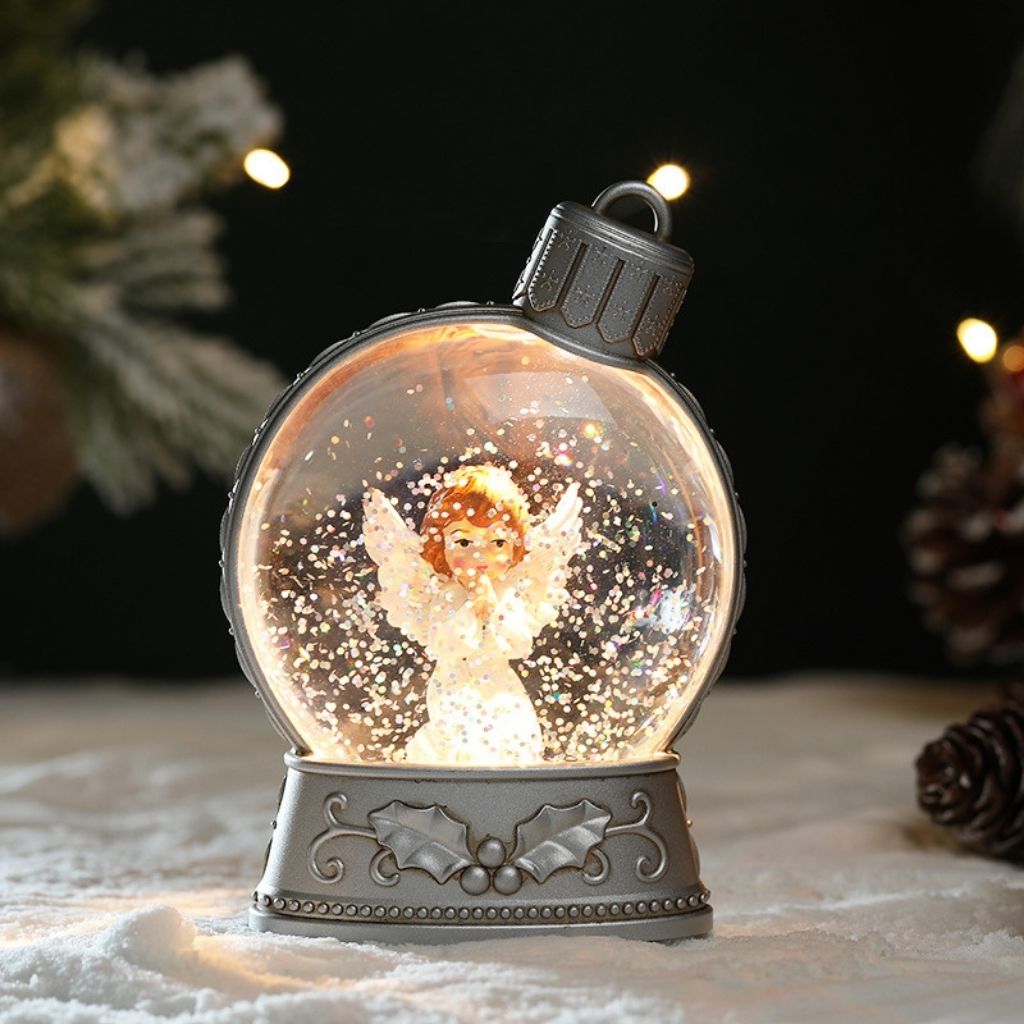 Lightweight plastic snow globe ornament with built in LED illumination