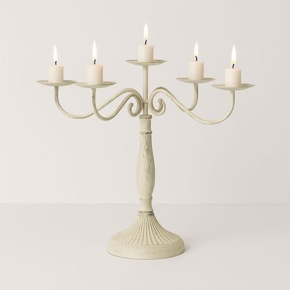 rnate metal candelabra with decorative scrollwork base holds multiple taper candles wedding centerpiece