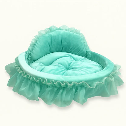 Cushioned cat bed with plush interior and ruffled trim detail
