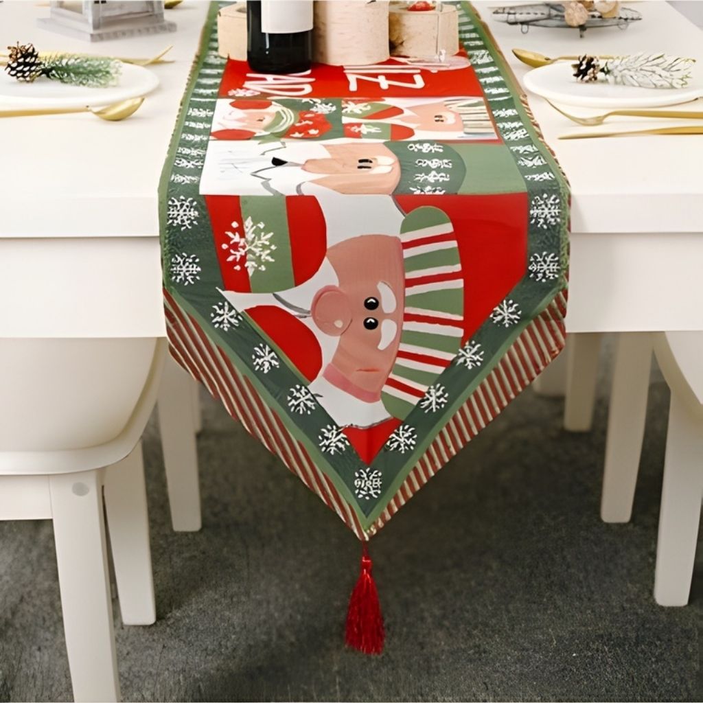 Festive table runner with holiday motifs and tassel trim full length view