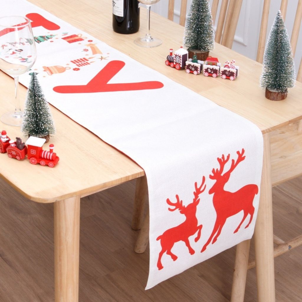 Red Christmas table runner with double sided print showing seasonal graphics