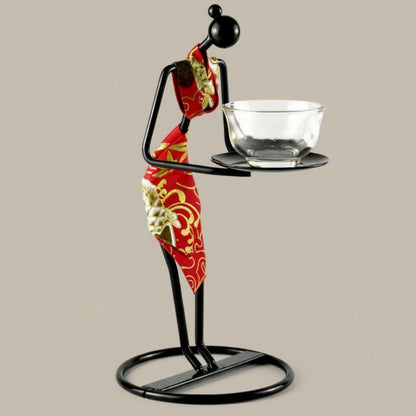 Asian tea ceremony art piece with iron figure holding traditional glass teacup