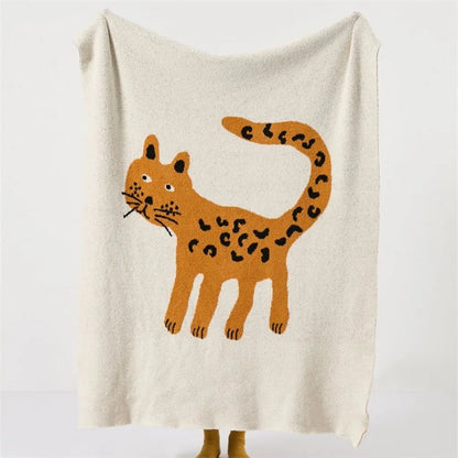 Spotted leopard velvet throw blanket with playful animal motif for cozy home styling