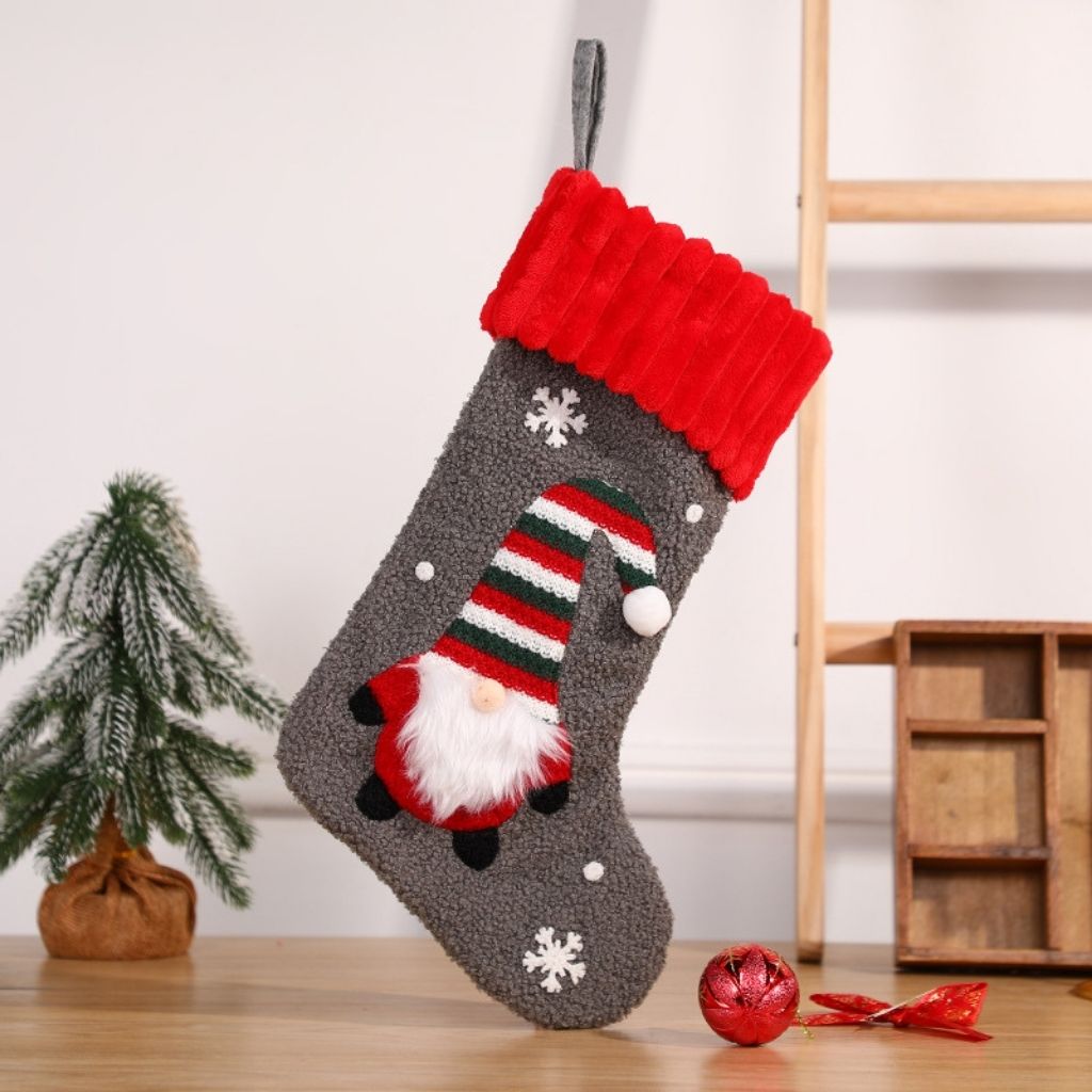 Festive holiday stocking featuring embroidered gnome motif on textured fabric
