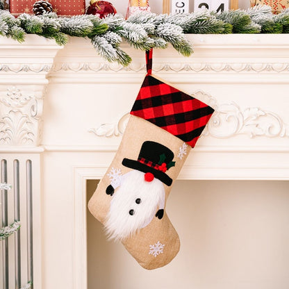 Christmas stocking with Santa face design hanging on a fireplace mantel.
