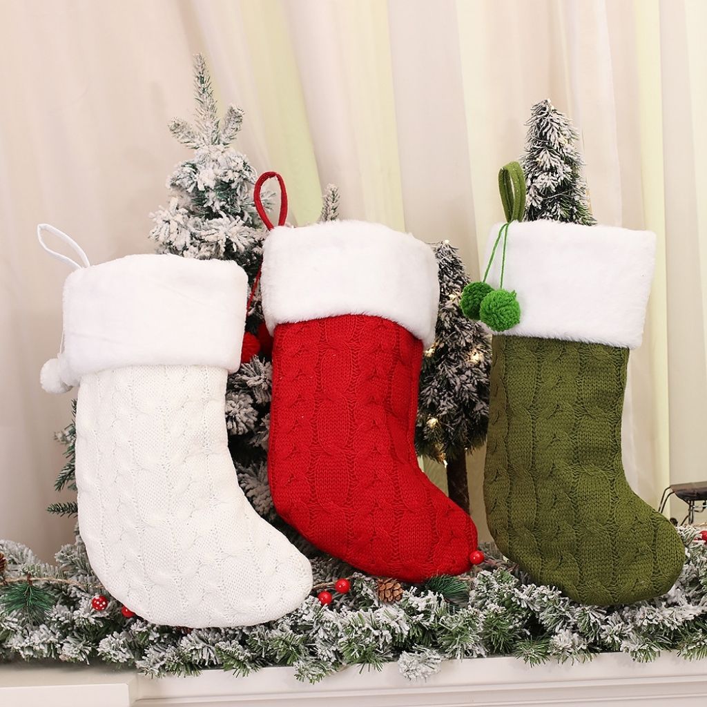 Knitted holiday stocking displaying traditional christmas pattern