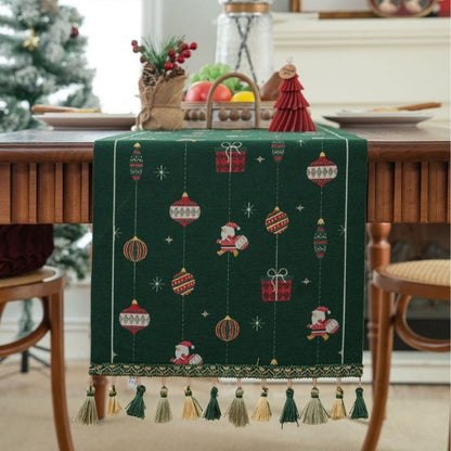 Green jacquard table runner with gift box pattern on white surface