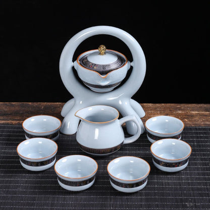  Gravity-fed ceramic tea set with rotating teapot and wide spout design