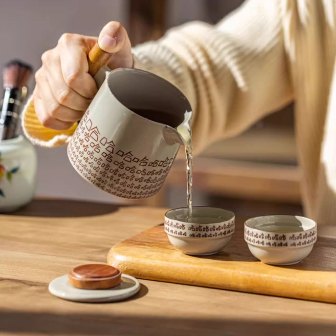 Portable tea ceremony set with ceramic teapot and cups for traditional tea rituals on the go