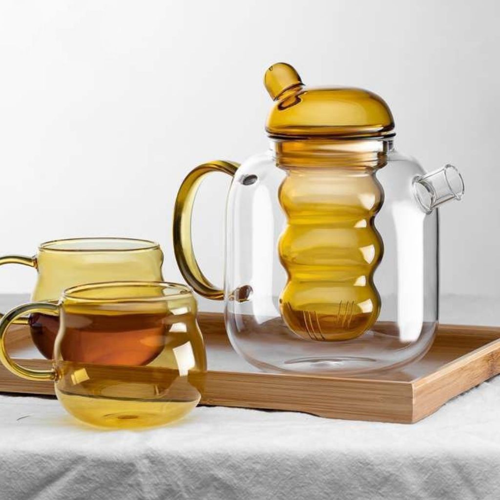 Modern glass teapot with minimalist design and functional internal filter system