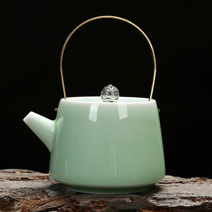 Blue celadon ceramic teapot with brass accent handle for tea service