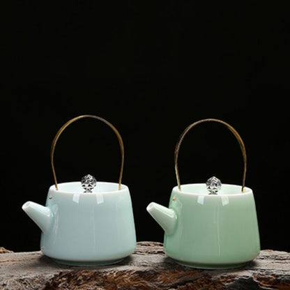 Glazed celadon pottery teapot with curved spout for tea steeping