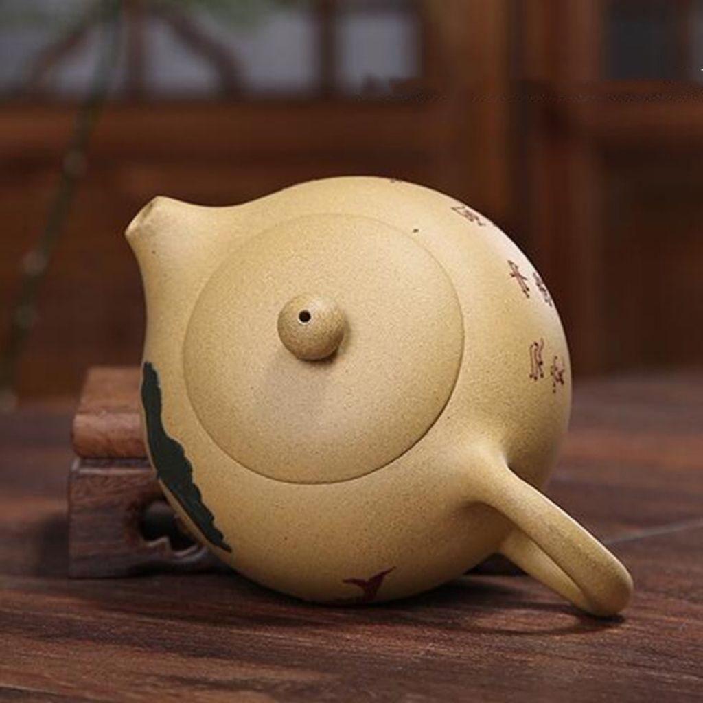Side profile of purple clay teapot showing ergonomic rounded handle and balanced structure