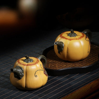 Hand carved clay teapot featuring enameled floral motifs and smooth finish