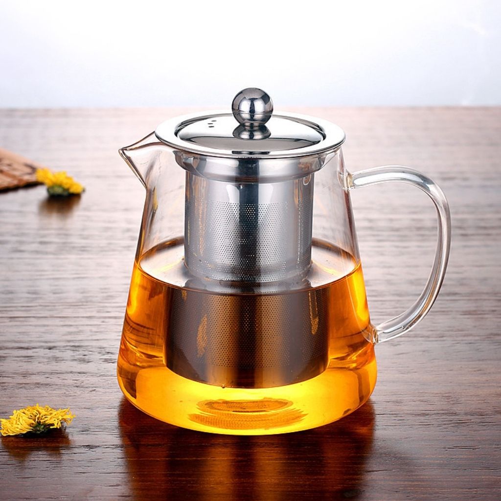 Heat resistant glass teapot showing transparent design with removable metal filter basket