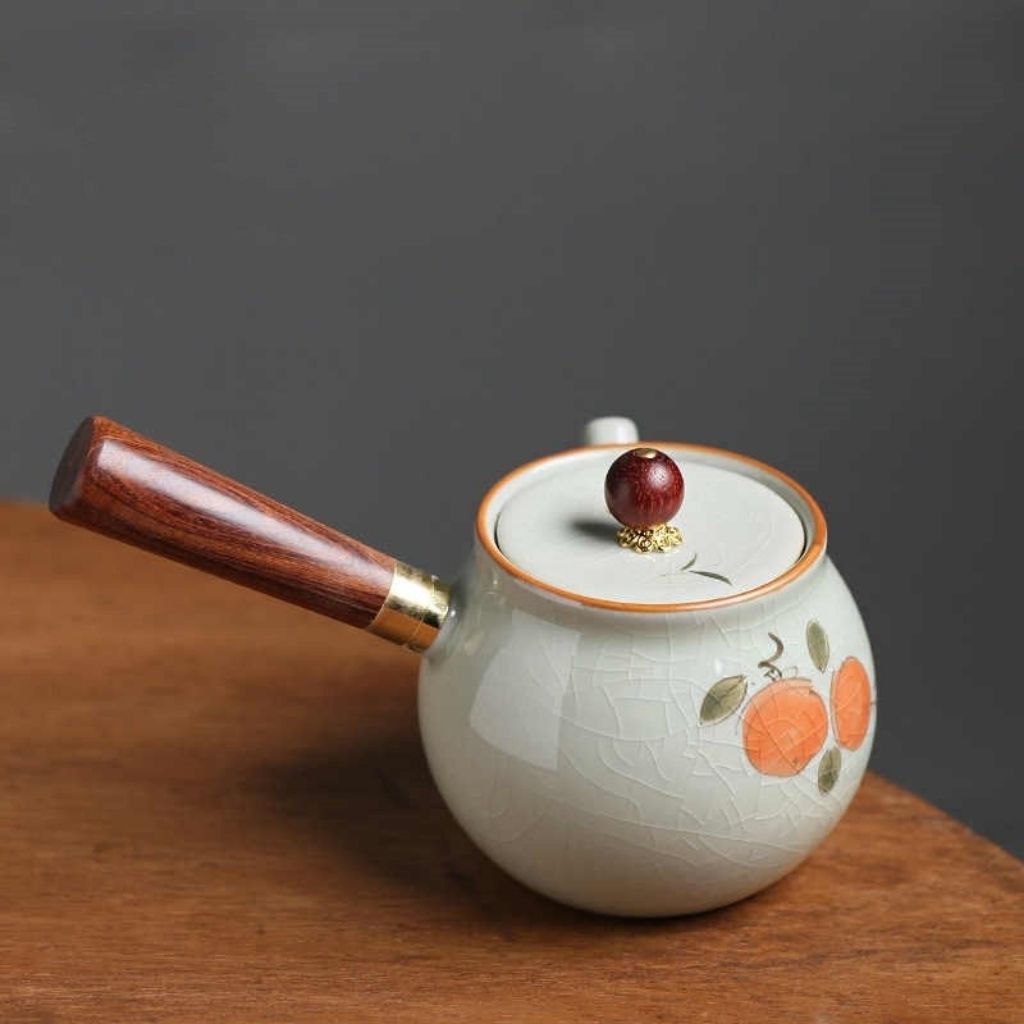 Crackle glaze finish on handcrafted ceramic teapot with persimmon artwork
