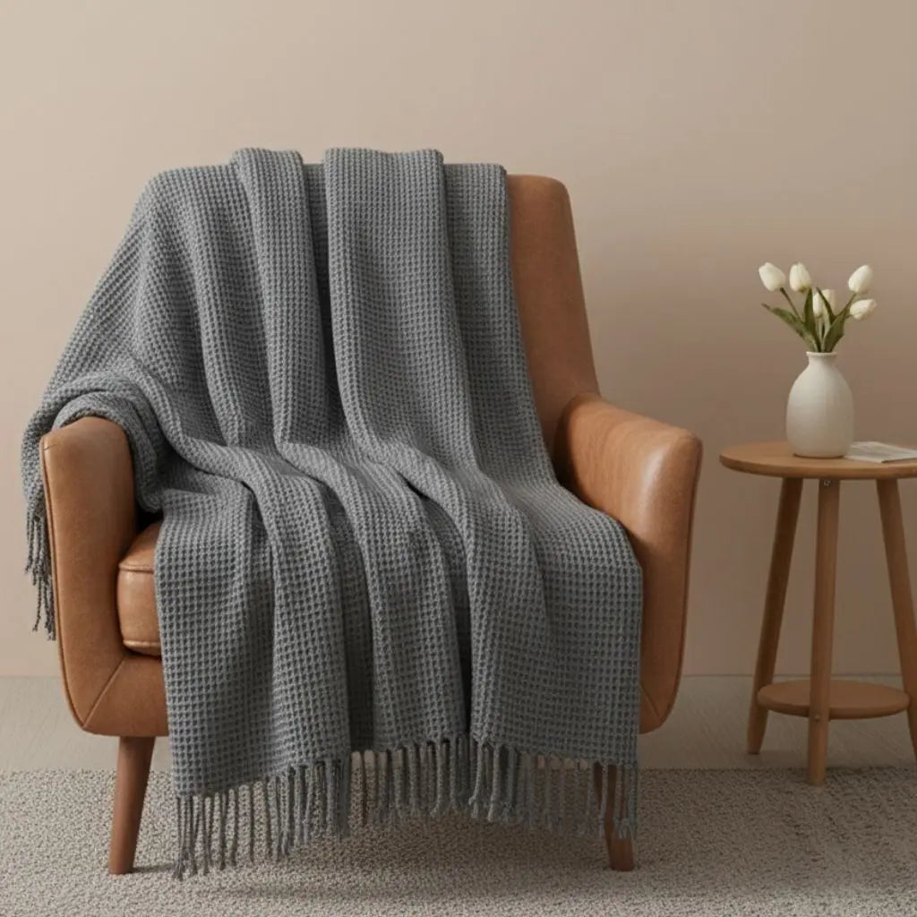 Sherpa throw blanket with flannel exterior and plush backing for cozy sofa comfort