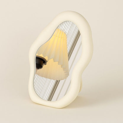 Sculptural cloud mirror mounted on wall showcasing modern irregular shape for contemporary home styling