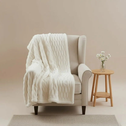 Faux fur throw blanket with bubble texture draped on modern sofa
