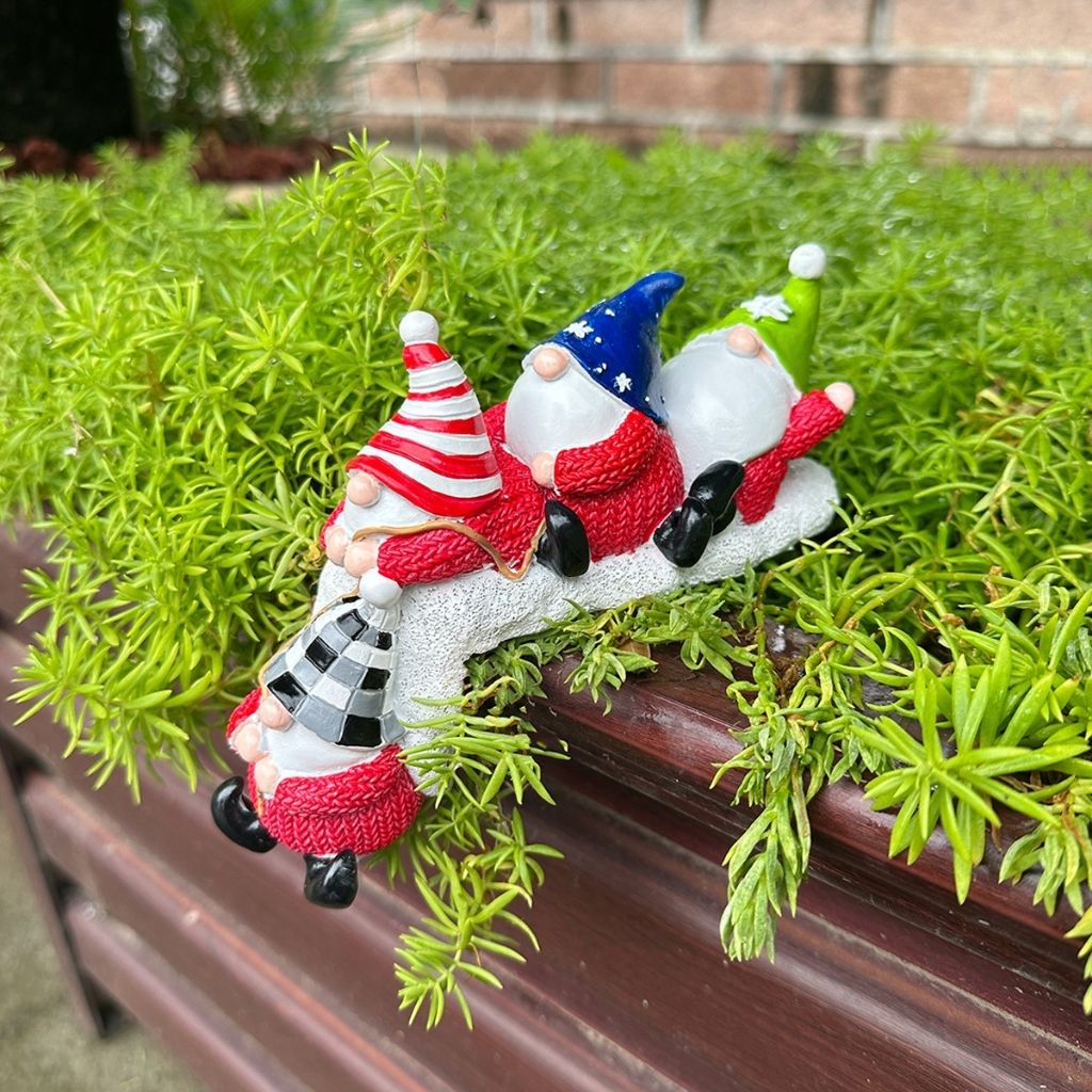 Christmas shelf decor with row of resin dwarfs designed to sit on edges and mantles for festive accent